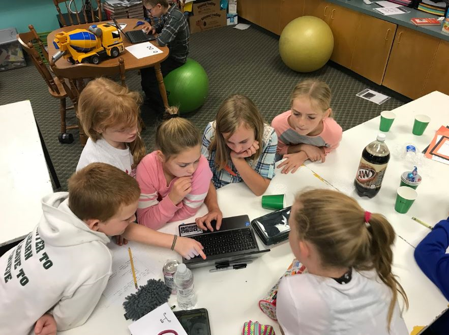 students working collaboratively using a computer